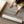 Whispers of Light rolled canvas print being unrolled – limited edition coastal wall art Australia