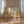 Over The Hills limited edition landscape paper print in oak frame leaning against sheer curtains in sunlit room – abstract golden hills wall art DT Art Studio.