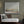Harmony's Promise limited edition landscape paper print in black frame on sage green wall above rattan daybed – abstract landscape wall art DT Art Studio.