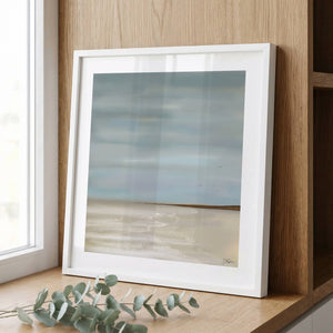 After The Rain limited edition paper print in white frame leaning against timber wall – abstract coastal wall art DT Art Studio.