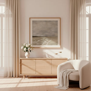 Whispers of Light abstract coastal paper print in oak frame above timber sideboard in sunlit cream living room – limited edition wall art DT Art Studio.