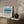Coastal Azure limited edition paper print in oak frame above timber sideboard – abstract seascape wall art DT Art Studio.