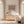 Dusk limited edition paper print in oak frame above timber sideboard in sunlit cream living room – abstract coastal wall art DT Art Studio.
