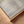 Detail of Unbound limited edition canvas print in oak frame – soft neutral sky and coastal tones