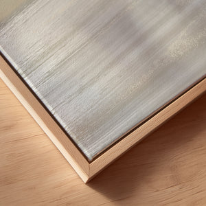 Detail of Unbound limited edition canvas print in oak frame – soft neutral sky and coastal tones
