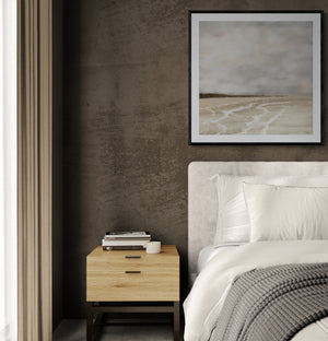 Whispers of Light limited edition paper print in black frame above bedside table in moody bedroom – abstract coastal wall art DT Art Studio.
