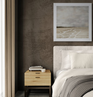 Whispers of Light limited edition paper print in white frame above bedside table in moody bedroom – abstract coastal wall art DT Art Studio.