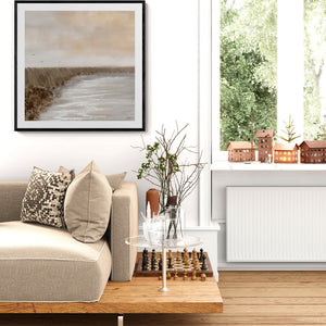 Coastal Serenity limited edition paper print in black frame styled in bright Scandinavian living room – Australian coastal wall art DT Art Studio.