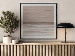 Dusk limited edition paper print in black frame above slatted timber sideboard with olive tree – abstract coastal wall art DT Art Studio.