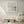 Unbound limited edition paper print in white frame above cream sideboard in minimalist living room – abstract coastal wall art DT Art Studio.