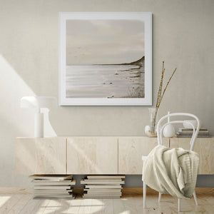 Unbound limited edition paper print in white frame above cream sideboard in minimalist living room – abstract coastal wall art DT Art Studio.